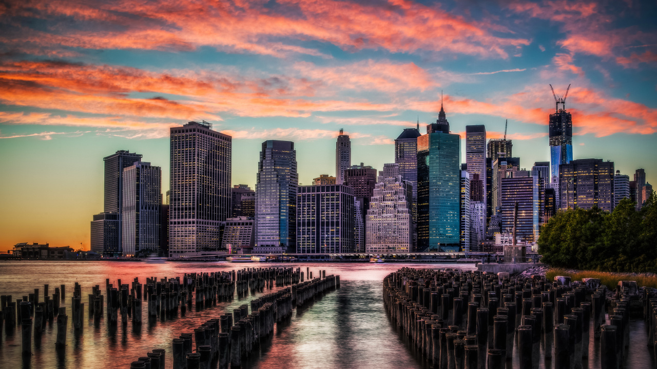 Bridge Over River Near City Skyline During Sunset. Wallpaper in 1280x720 Resolution