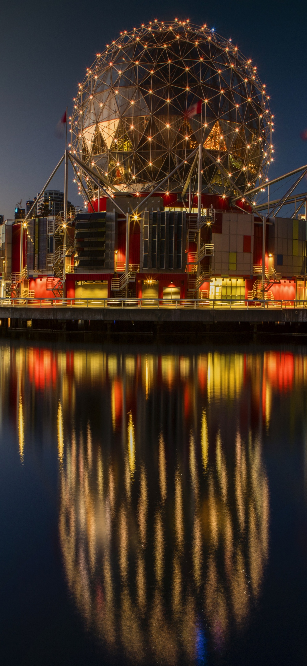City Skyline Across Body of Water During Night Time. Wallpaper in 1242x2688 Resolution