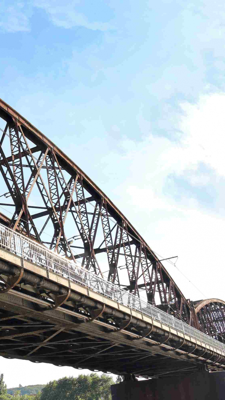 Brown Metal Bridge Under Blue Sky During Daytime. Wallpaper in 750x1334 Resolution