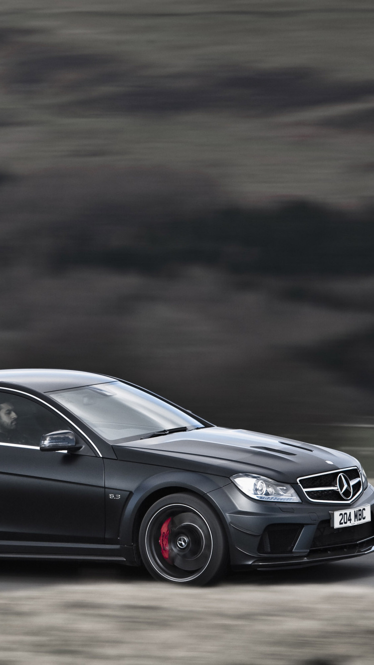 Black Mercedes Benz Coupe on Road. Wallpaper in 750x1334 Resolution