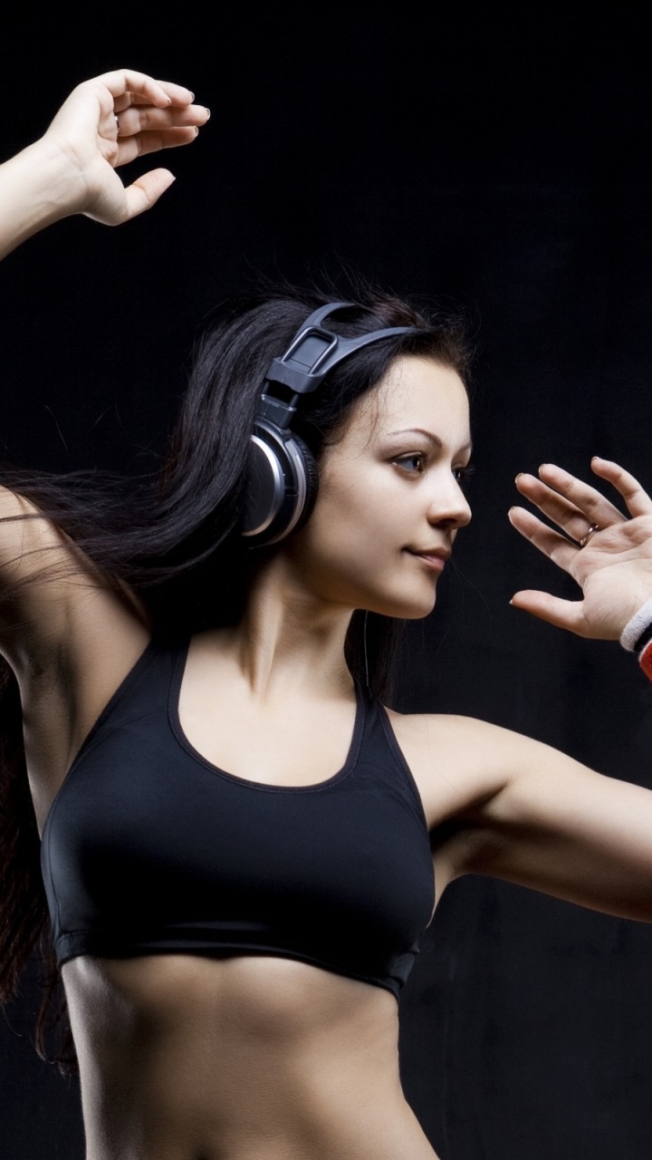 Woman in Black Sports Bra Holding Her Hair. Wallpaper in 720x1280 Resolution