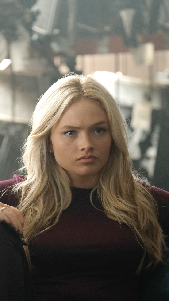 Woman in Maroon Long Sleeve Shirt Sitting on Black Leather Couch. Wallpaper in 720x1280 Resolution