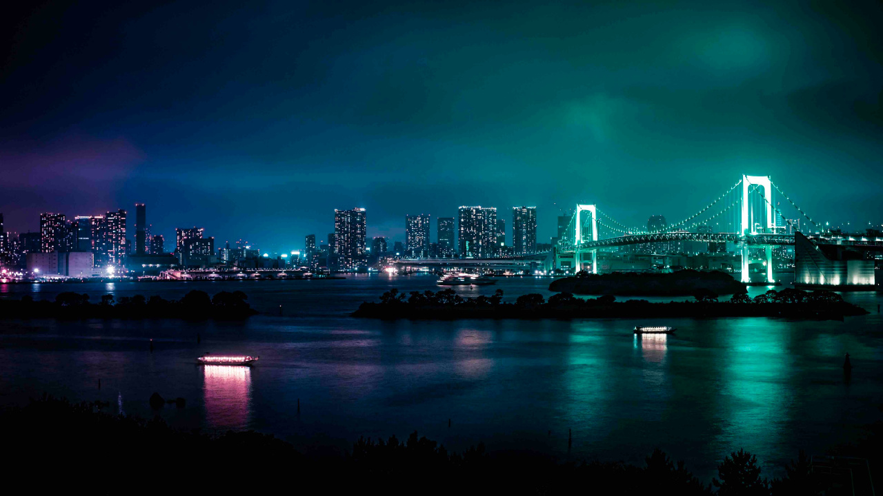 Bridge Over Water Near City Skyline During Night Time. Wallpaper in 1280x720 Resolution