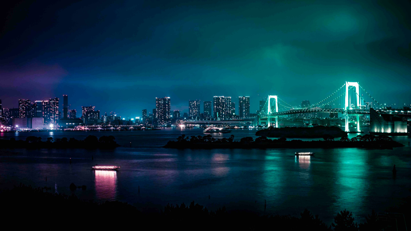 Bridge Over Water Near City Skyline During Night Time. Wallpaper in 1366x768 Resolution
