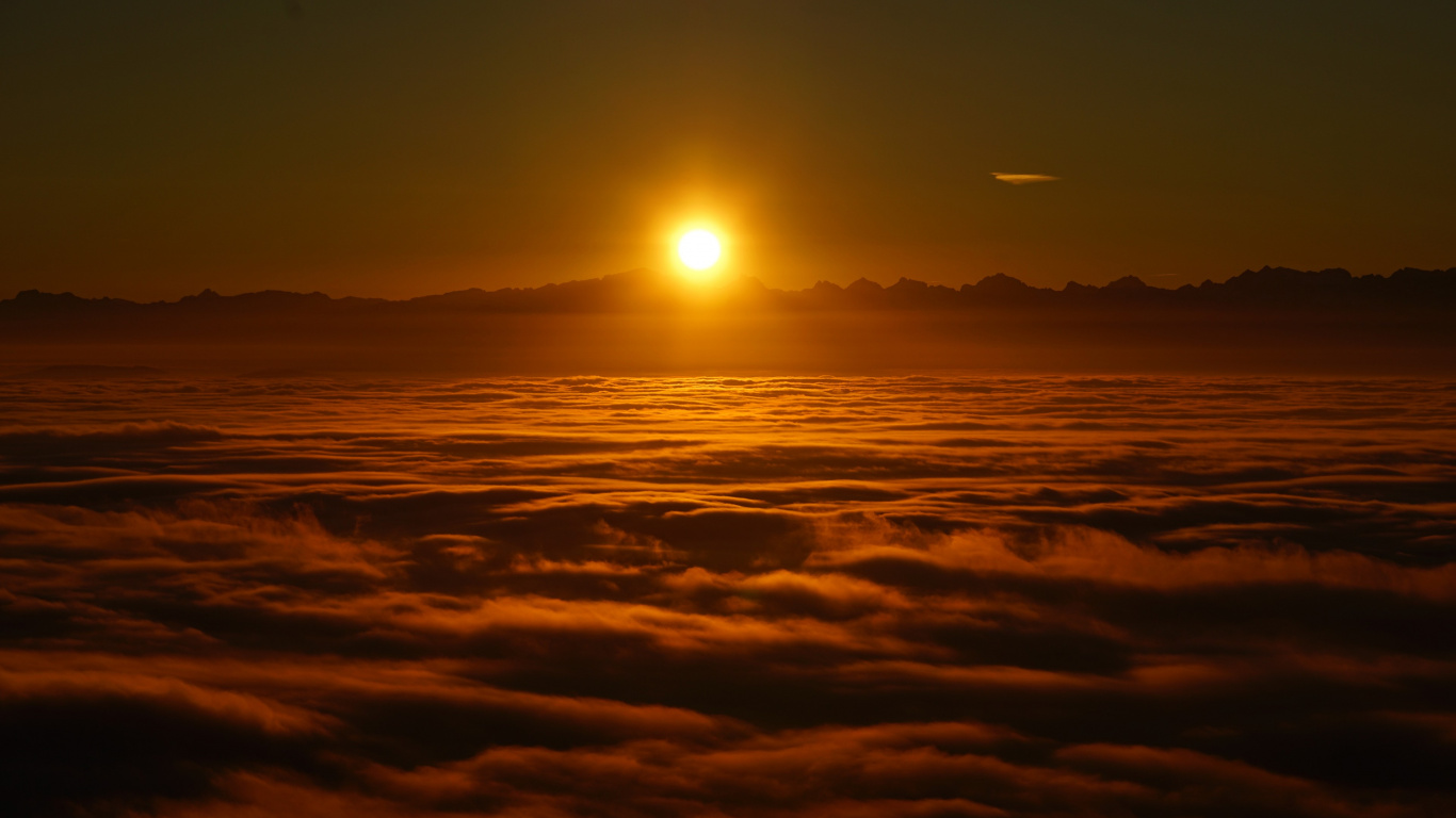 Sun Setting Over The Clouds. Wallpaper in 1366x768 Resolution