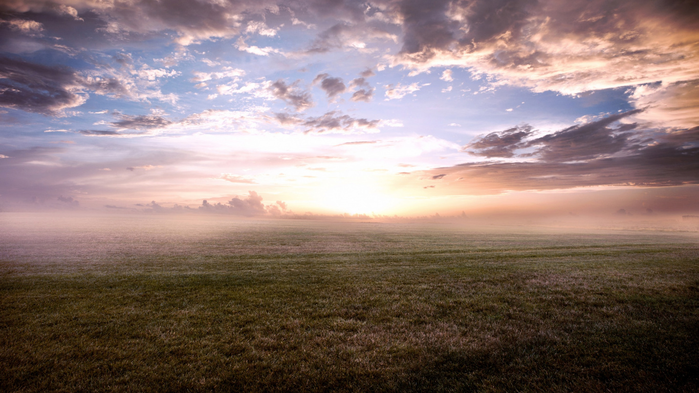 Green Grass Field Under Cloudy Sky During Daytime. Wallpaper in 1366x768 Resolution