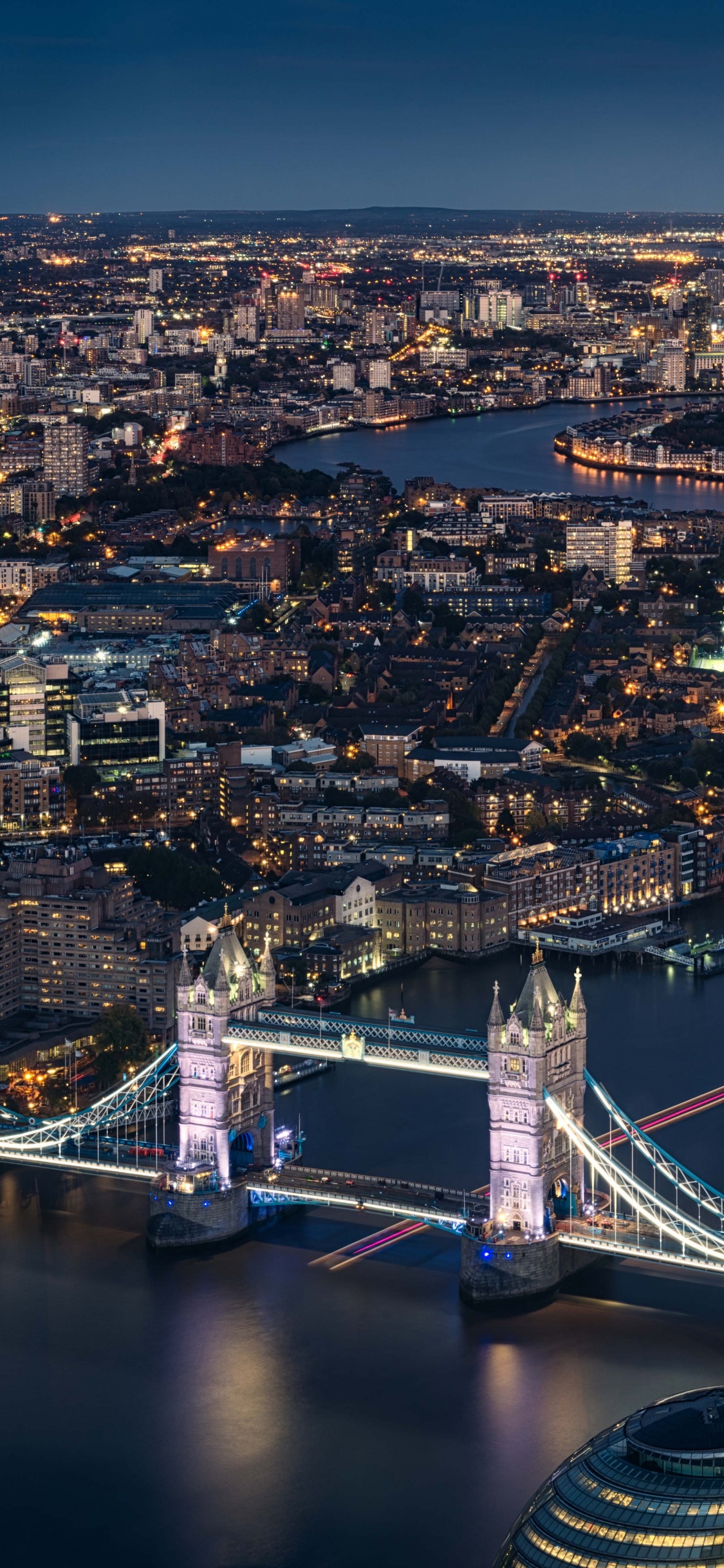 Aerial View of City Buildings During Night Time. Wallpaper in 1125x2436 Resolution