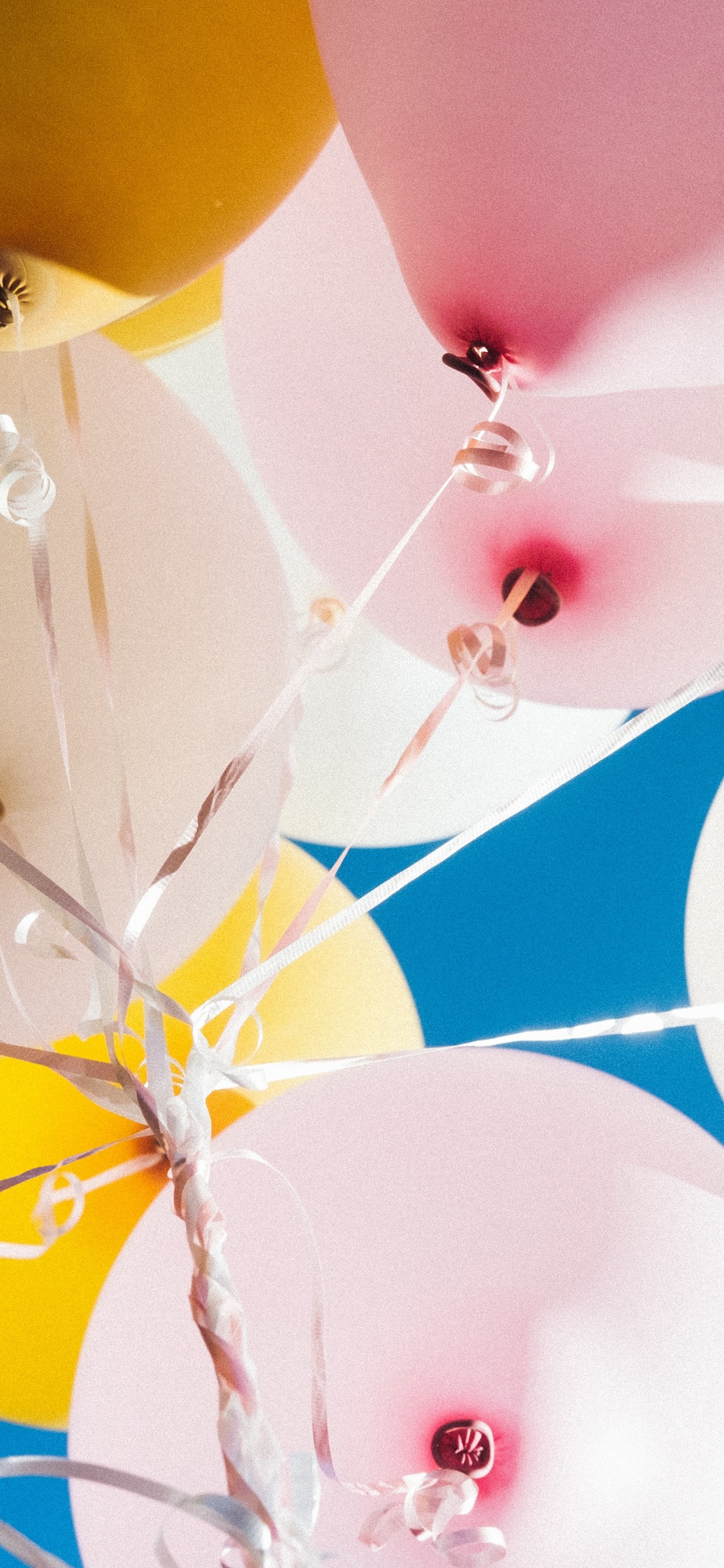Yellow Blue and Pink Balloons. Wallpaper in 1125x2436 Resolution