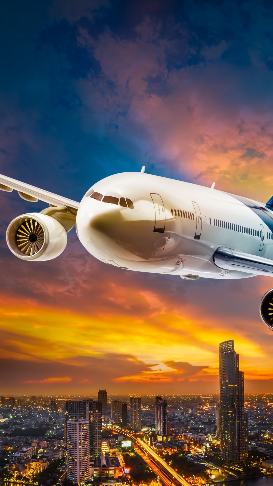 White Passenger Plane Flying Over City Buildings During Daytime. Wallpaper in 1080x1920 Resolution