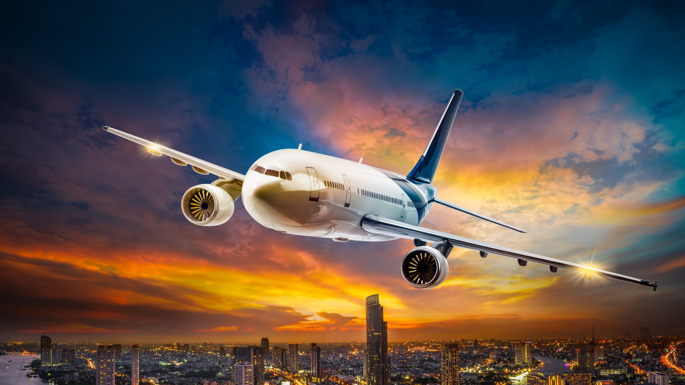 White Passenger Plane Flying Over City Buildings During Daytime. Wallpaper in 1366x768 Resolution