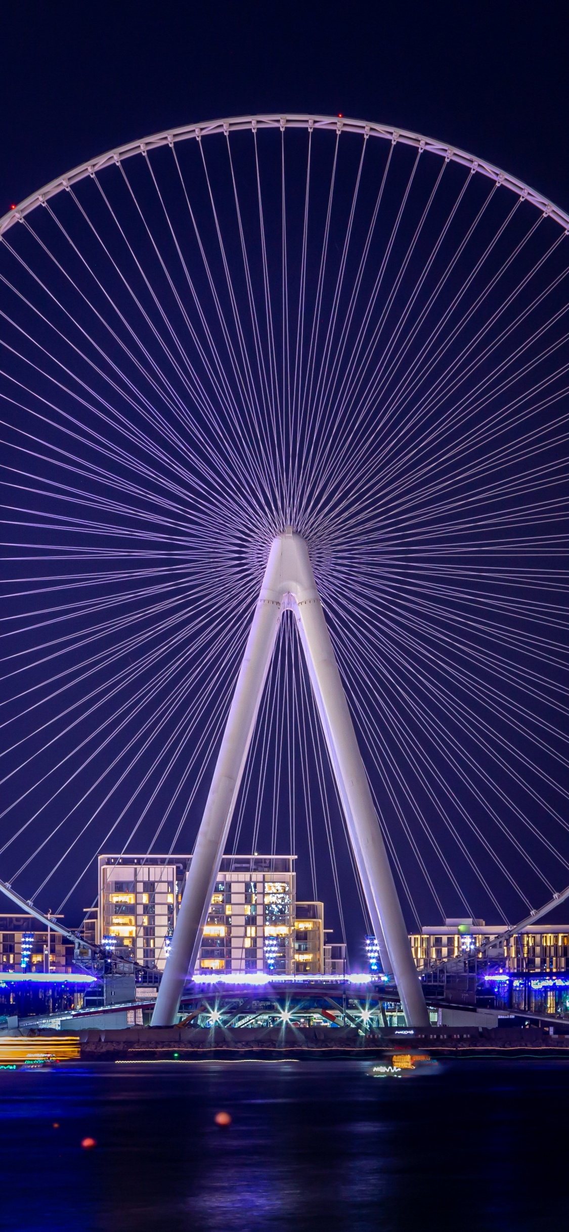 Ferris Wheel Landscape Dubai Uae Night Lights. Wallpaper in 1125x2436 Resolution