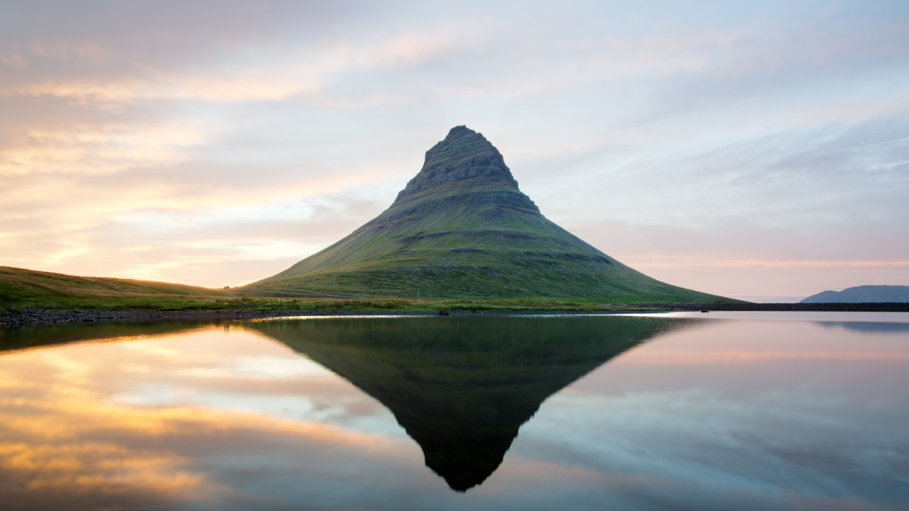 Green Mountain Beside Body of Water Under Cloudy Sky During Daytime. Wallpaper in 1280x720 Resolution