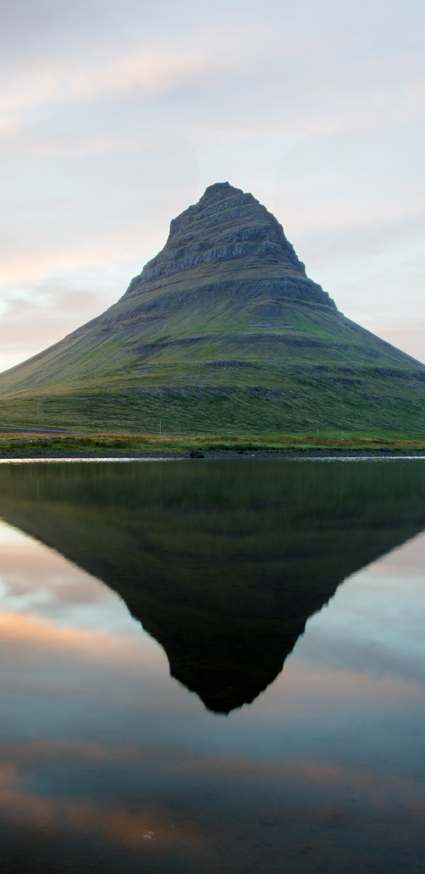 Green Mountain Beside Body of Water Under Cloudy Sky During Daytime. Wallpaper in 1440x2960 Resolution