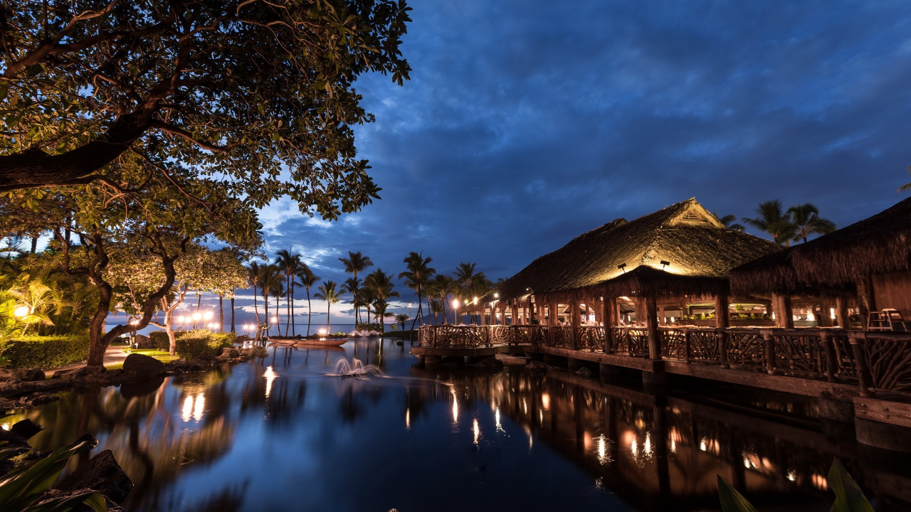 Brown Wooden House Near Body of Water During Night Time. Wallpaper in 1280x720 Resolution