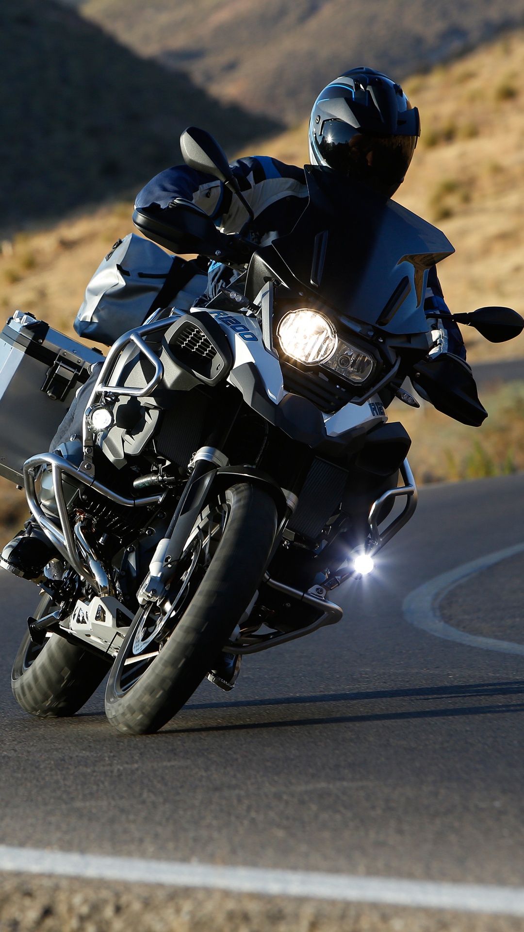 Man in Black Motorcycle Suit Riding Motorcycle on Road During Daytime. Wallpaper in 1080x1920 Resolution