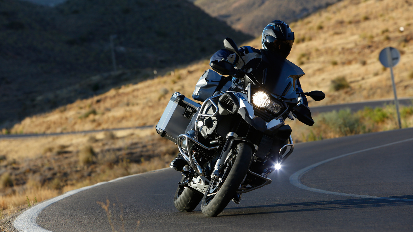 Man in Black Motorcycle Suit Riding Motorcycle on Road During Daytime. Wallpaper in 1366x768 Resolution