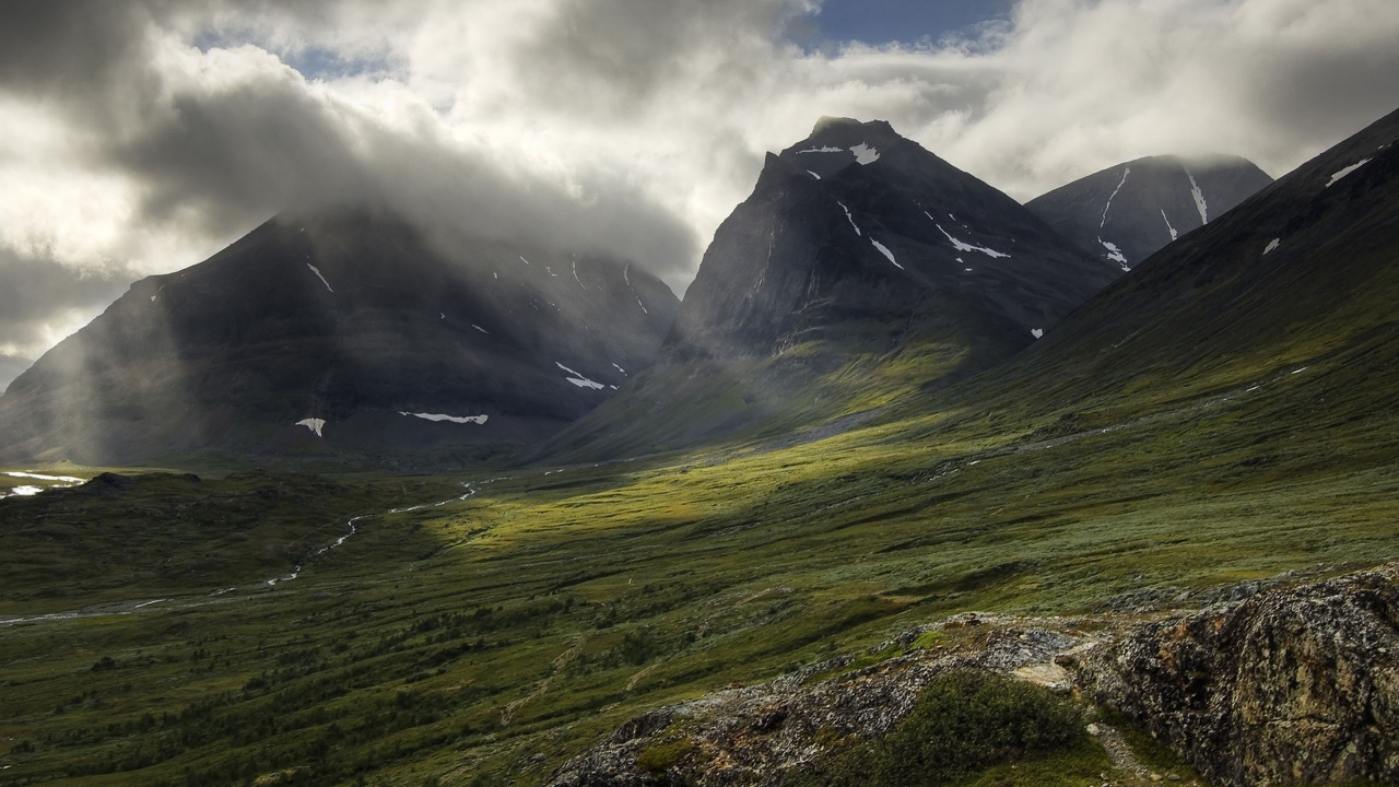 Green Grass Field Near Mountain Under Cloudy Sky During Daytime. Wallpaper in 1280x720 Resolution