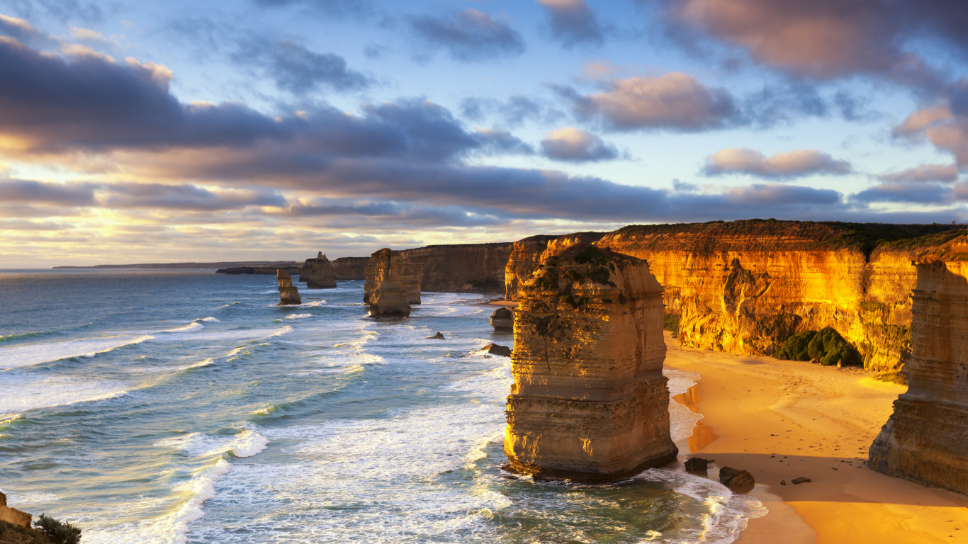 Brown Rock Formation on Sea Shore Under Cloudy Sky During Daytime. Wallpaper in 1366x768 Resolution