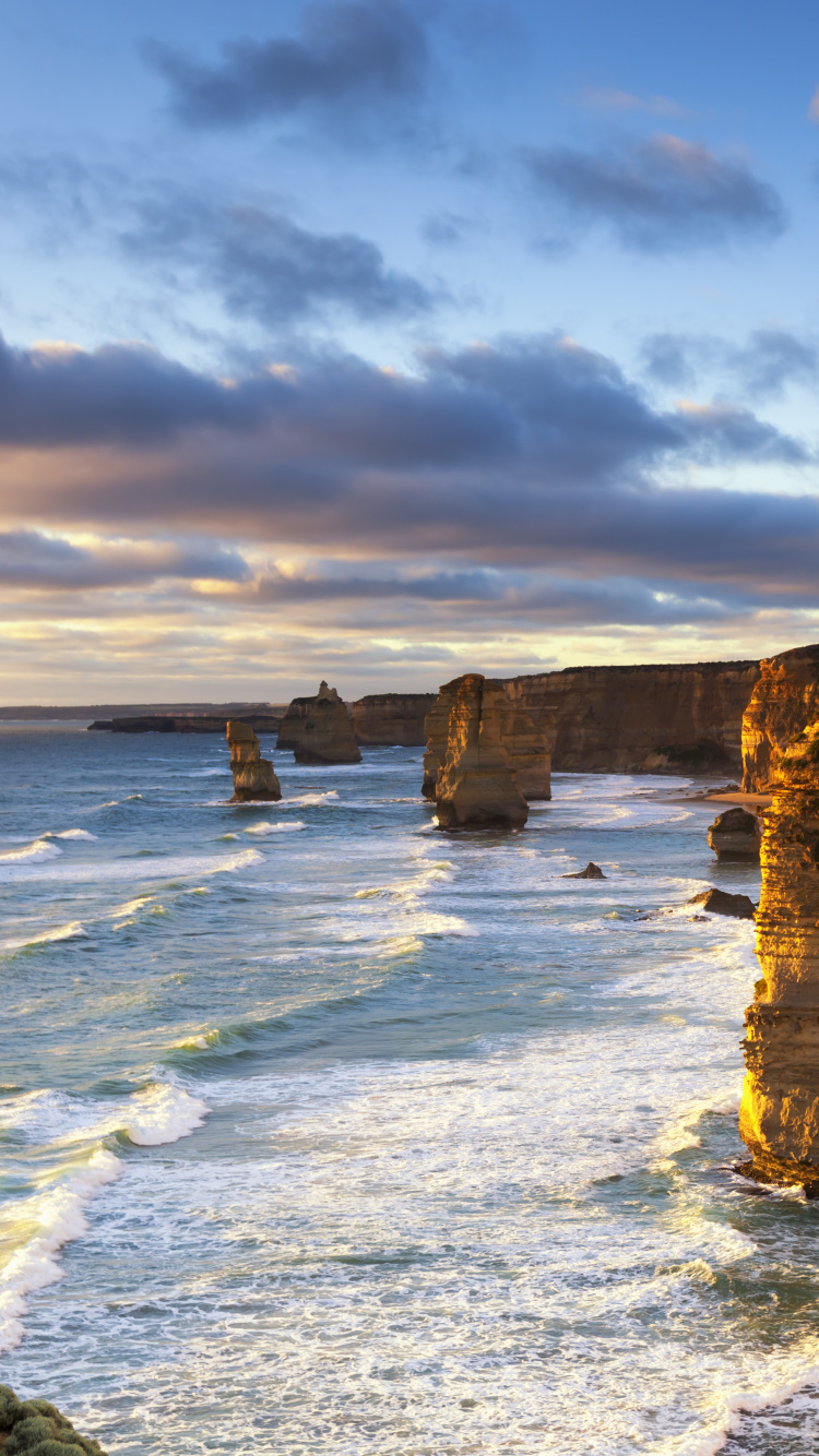 Brown Rock Formation on Sea Shore Under Cloudy Sky During Daytime. Wallpaper in 750x1334 Resolution