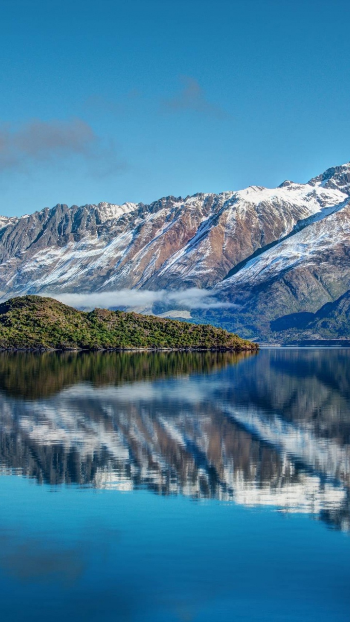 Snow Covered Mountain Near Lake During Daytime. Wallpaper in 720x1280 Resolution
