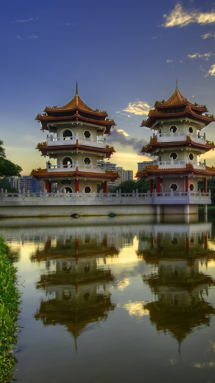 Braunes Und Weißes Betongebäude in Der Nähe Eines Gewässers Tagsüber. Wallpaper in 750x1334 Resolution