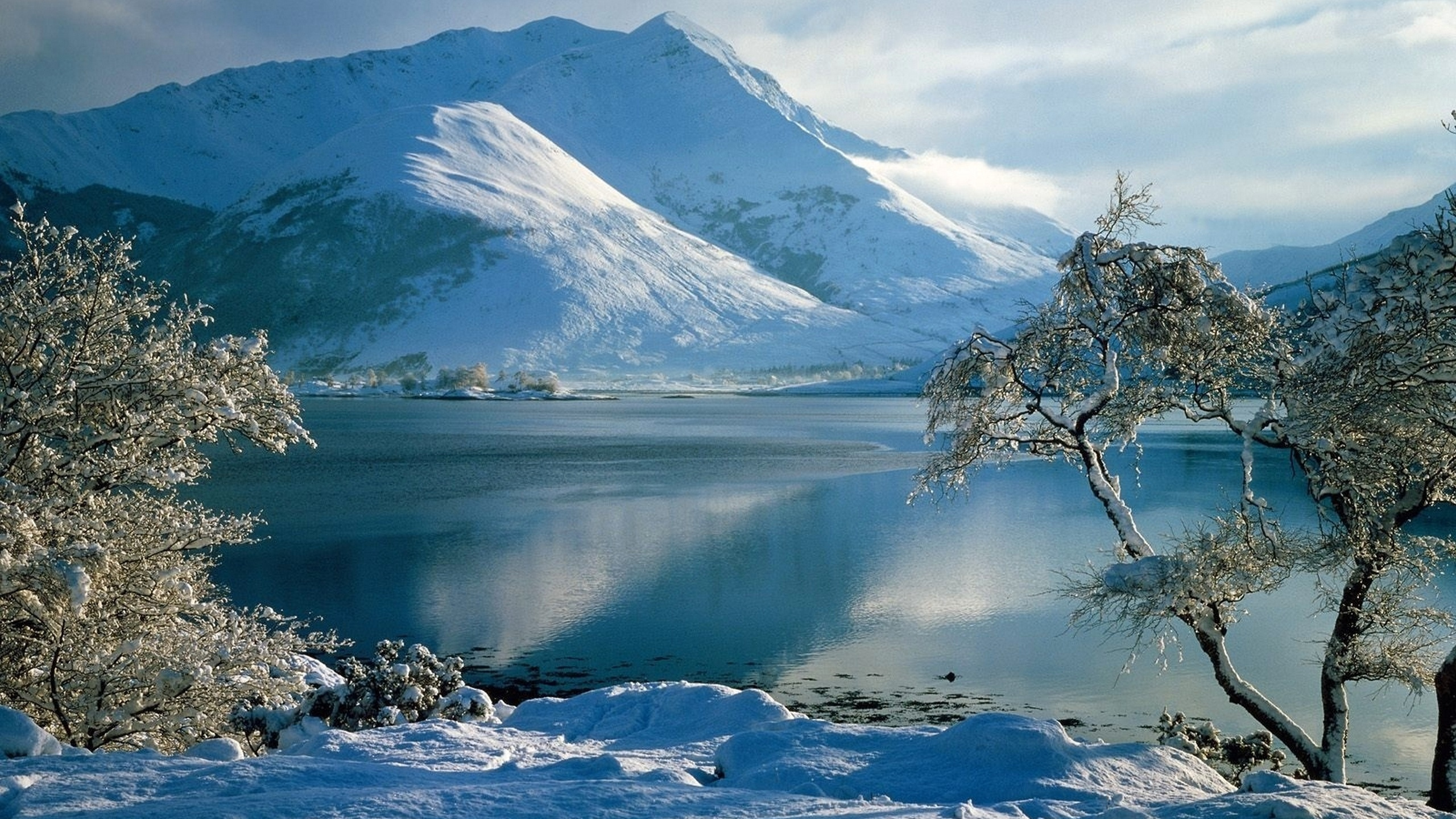 Snow Covered Mountain Near Body of Water During Daytime. Wallpaper in 2560x1440 Resolution