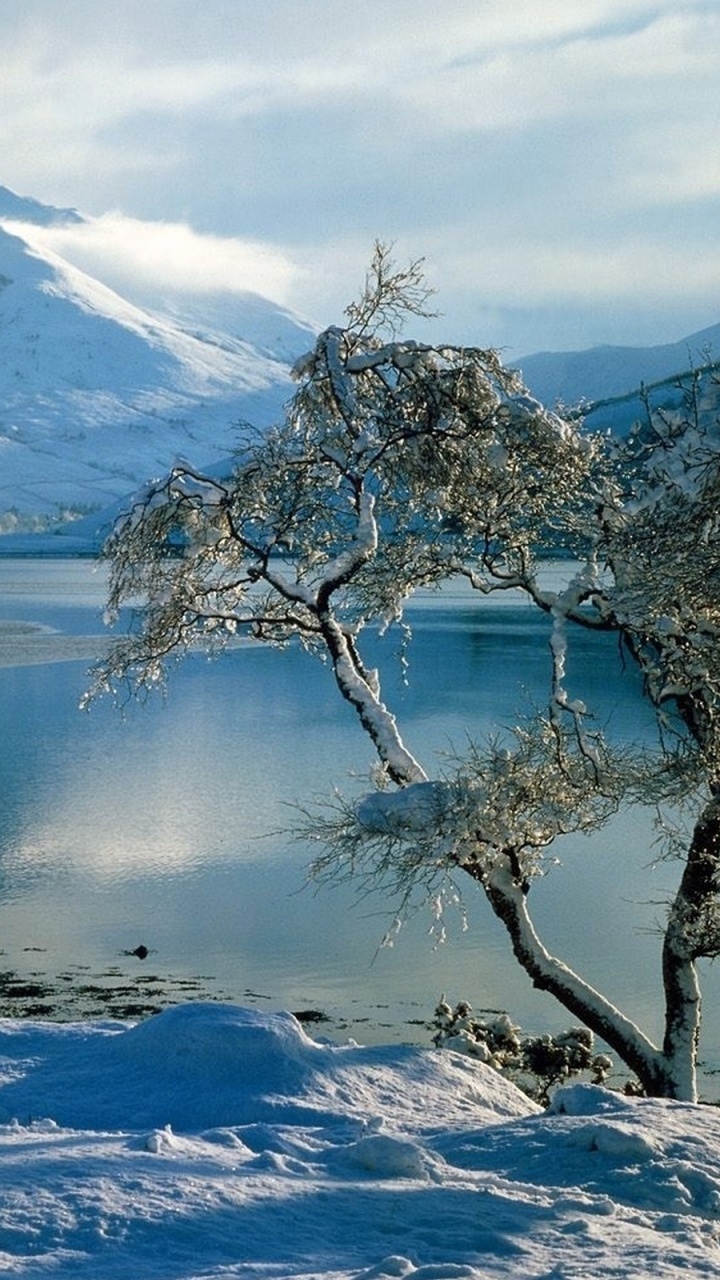 Snow Covered Mountain Near Body of Water During Daytime. Wallpaper in 720x1280 Resolution