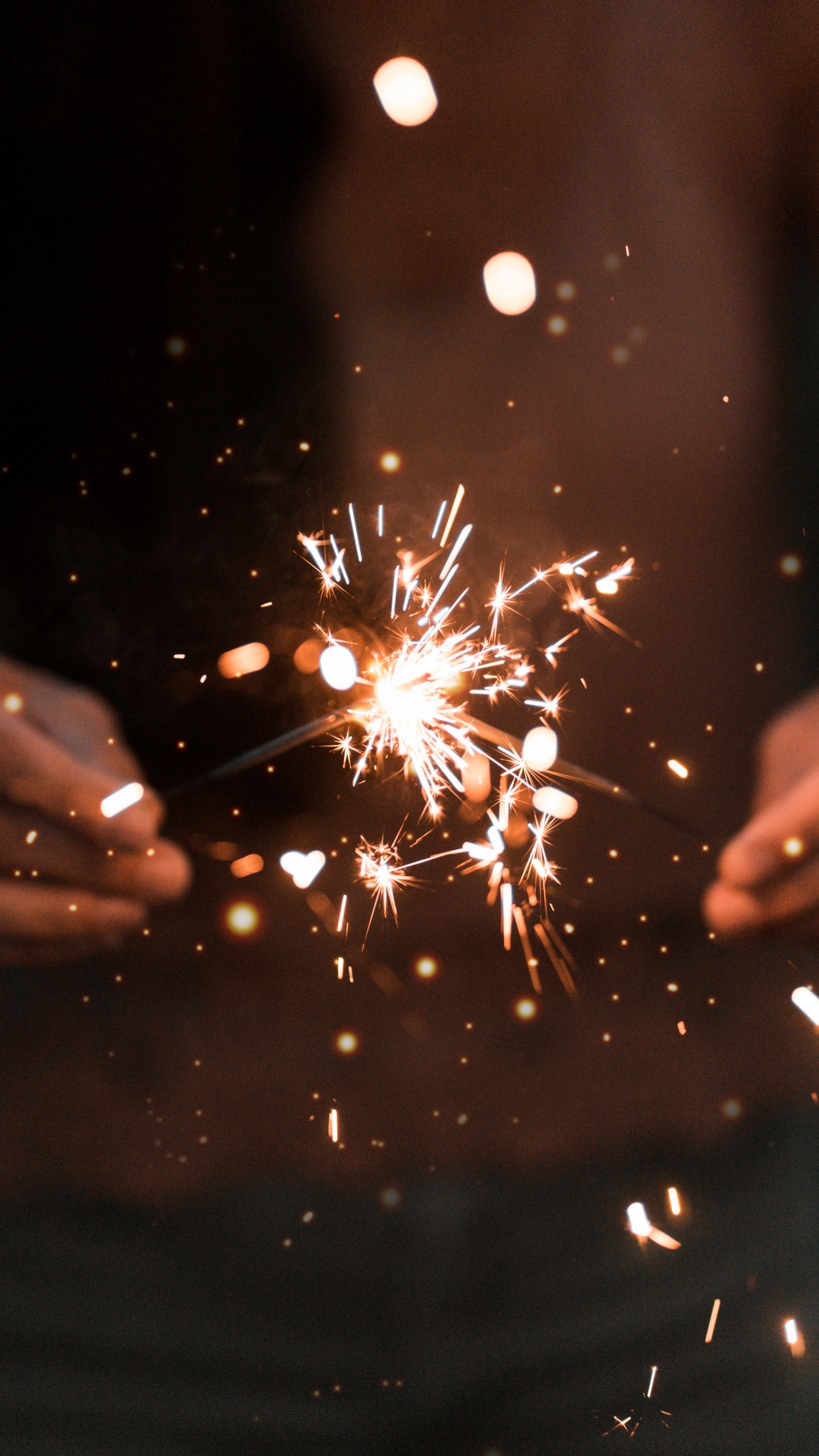Person Holding Sparkler During Night Time. Wallpaper in 1440x2560 Resolution