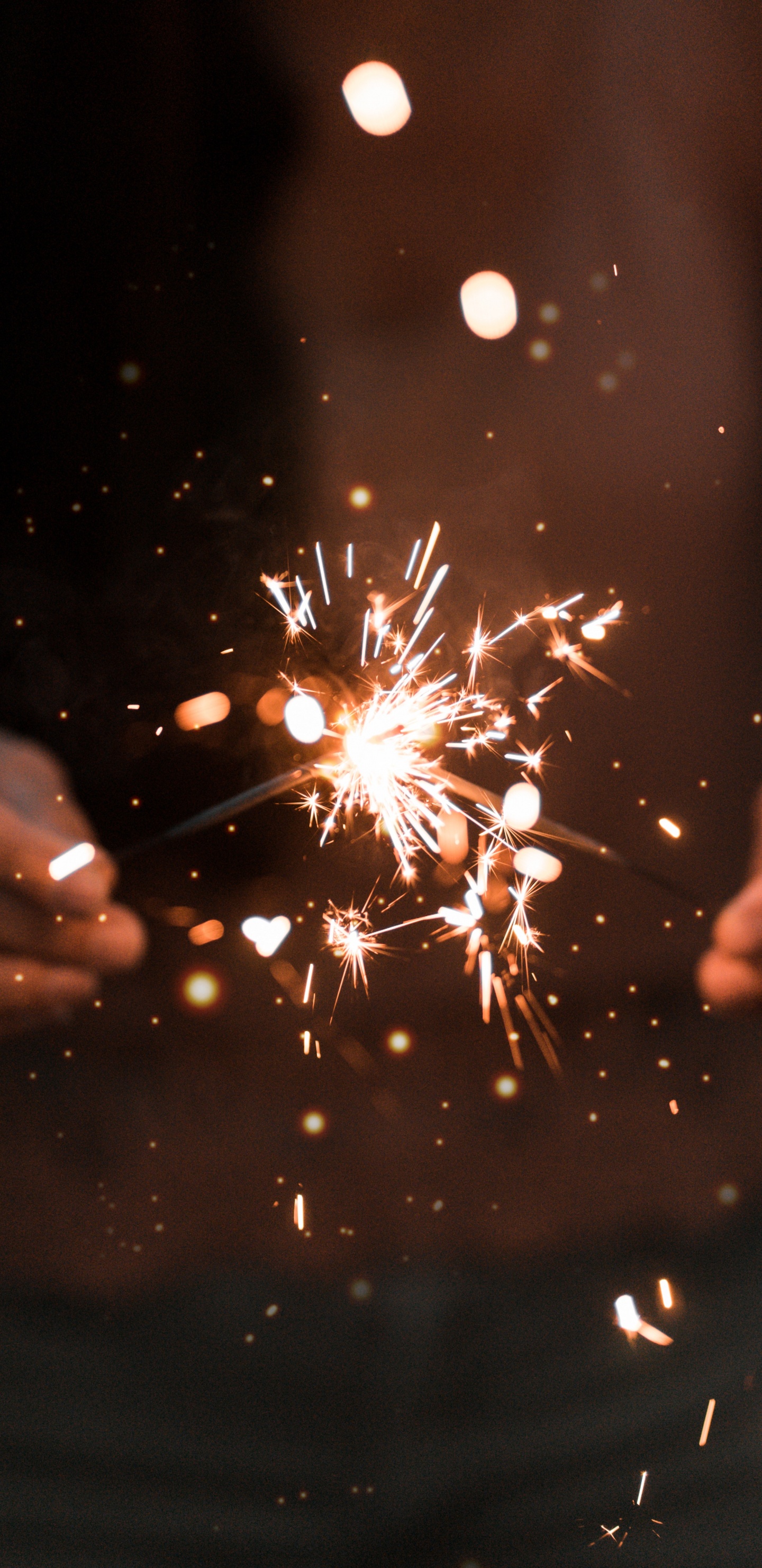 Person Holding Sparkler During Night Time. Wallpaper in 1440x2960 Resolution