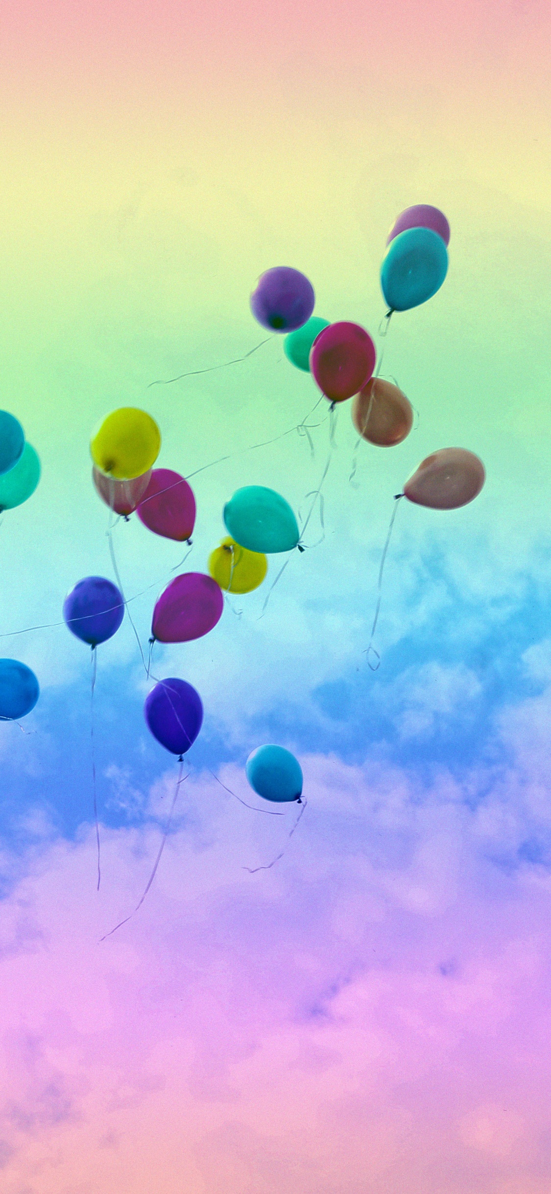 Blue and Green Balloons Under Blue Sky During Daytime. Wallpaper in 1125x2436 Resolution