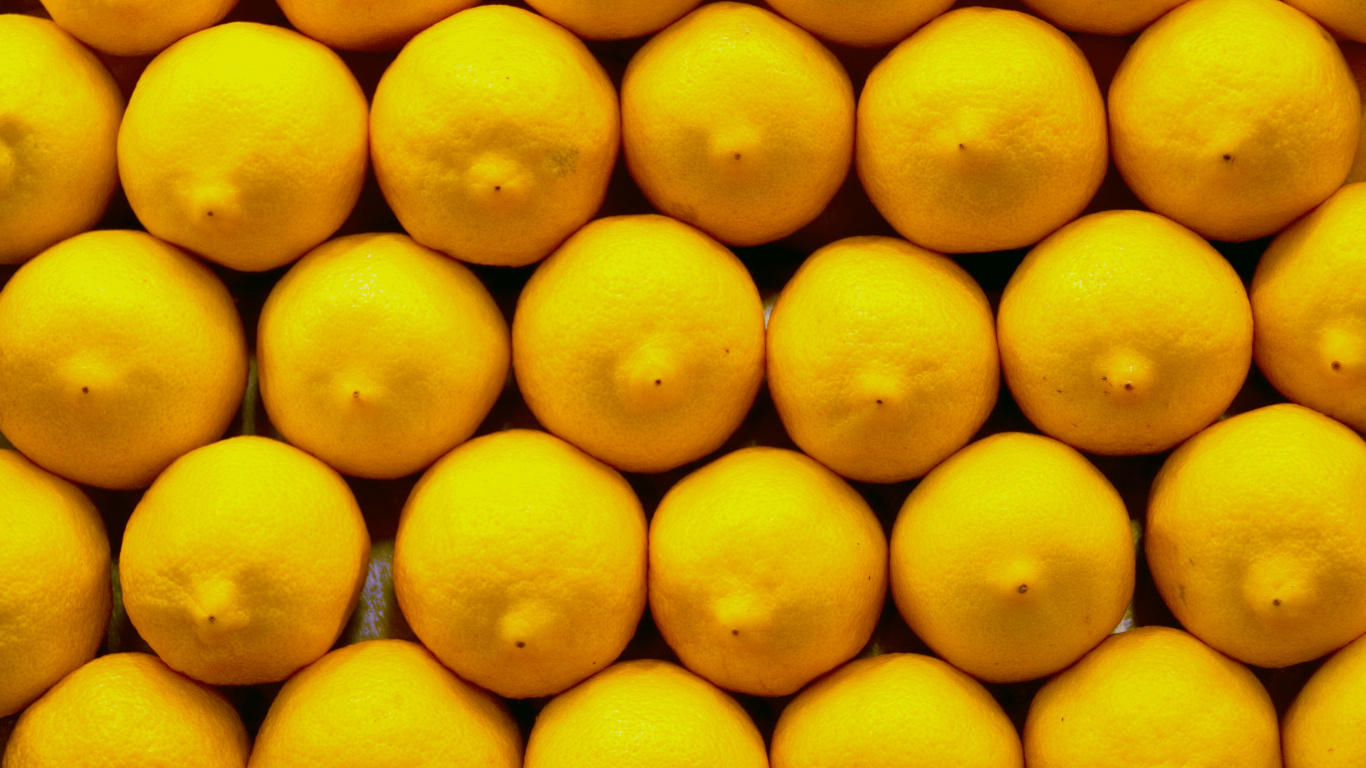 Yellow Lemon Fruit on Black Surface. Wallpaper in 1366x768 Resolution