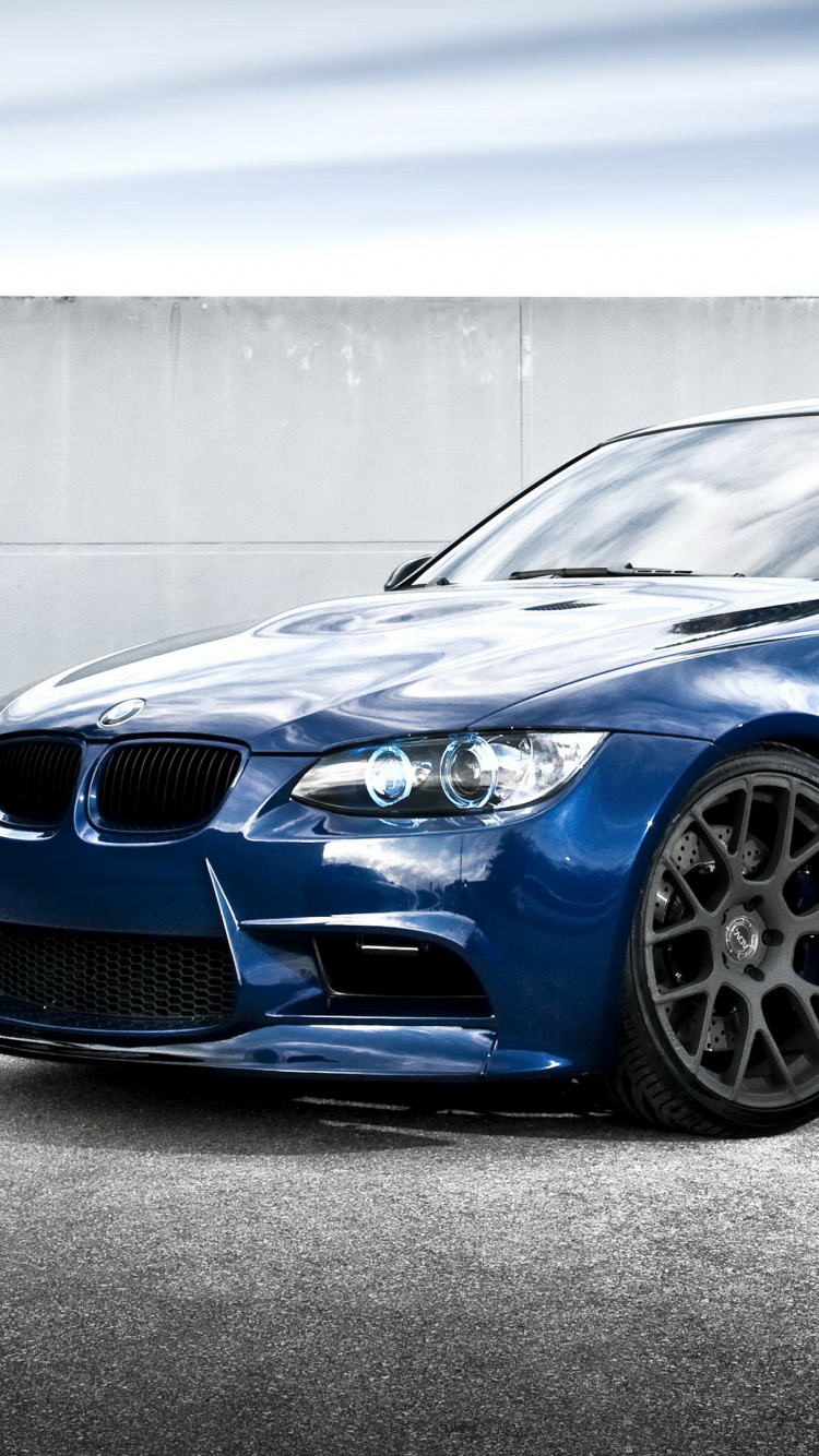 Blaues Bmw m 3 Coupe Auf Grauem Betonpflaster Geparkt. Wallpaper in 750x1334 Resolution