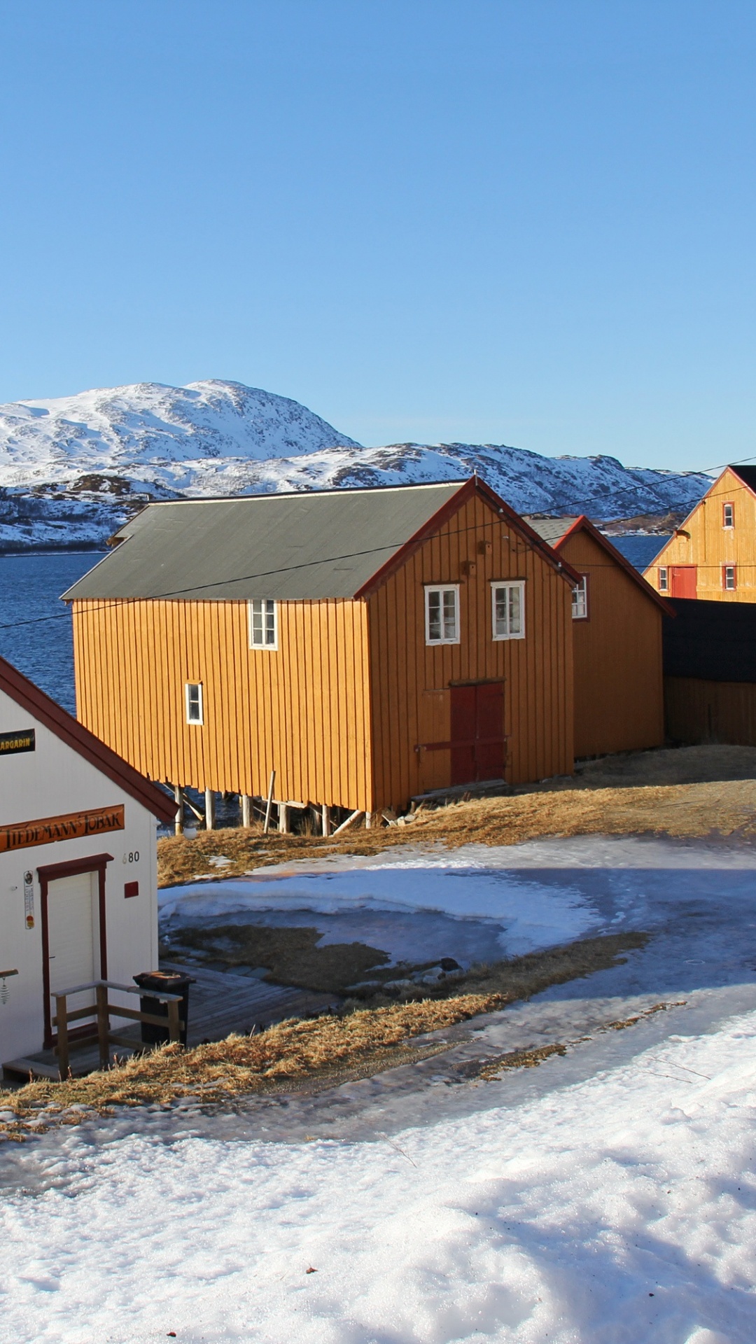 Brown and White Wooden Houses on Snow Covered Ground During Daytime. Wallpaper in 1080x1920 Resolution