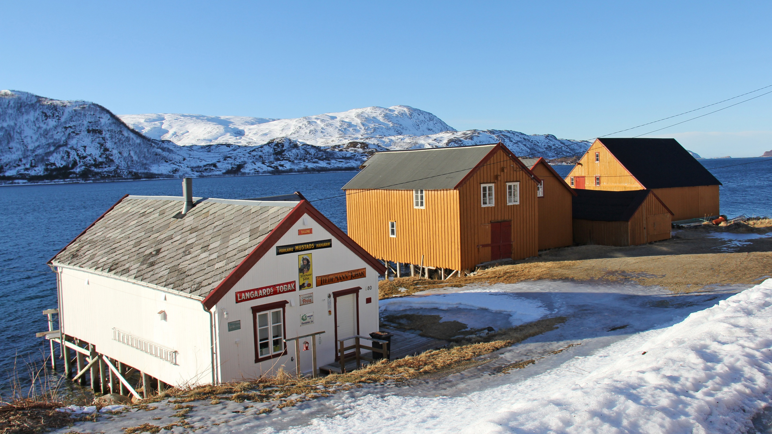 Brown and White Wooden Houses on Snow Covered Ground During Daytime. Wallpaper in 2560x1440 Resolution