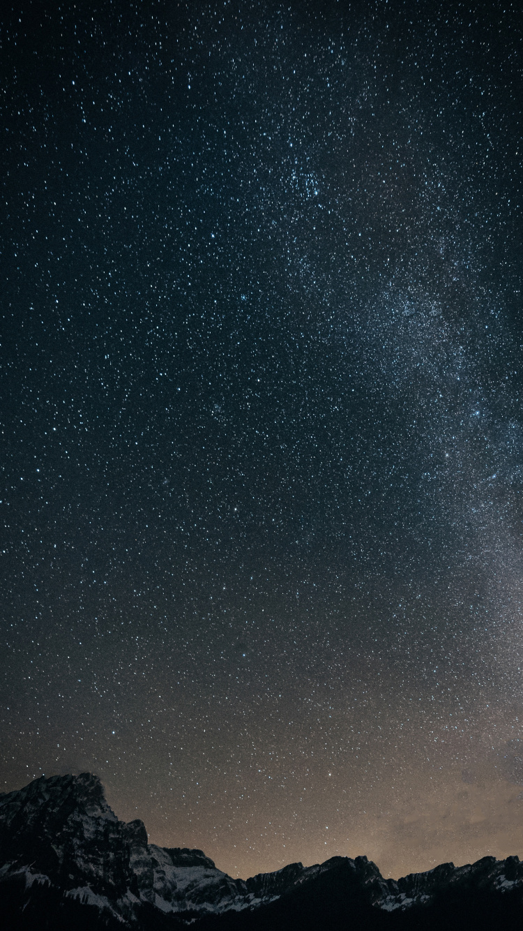 Black and White Mountain Under Starry Night. Wallpaper in 750x1334 Resolution