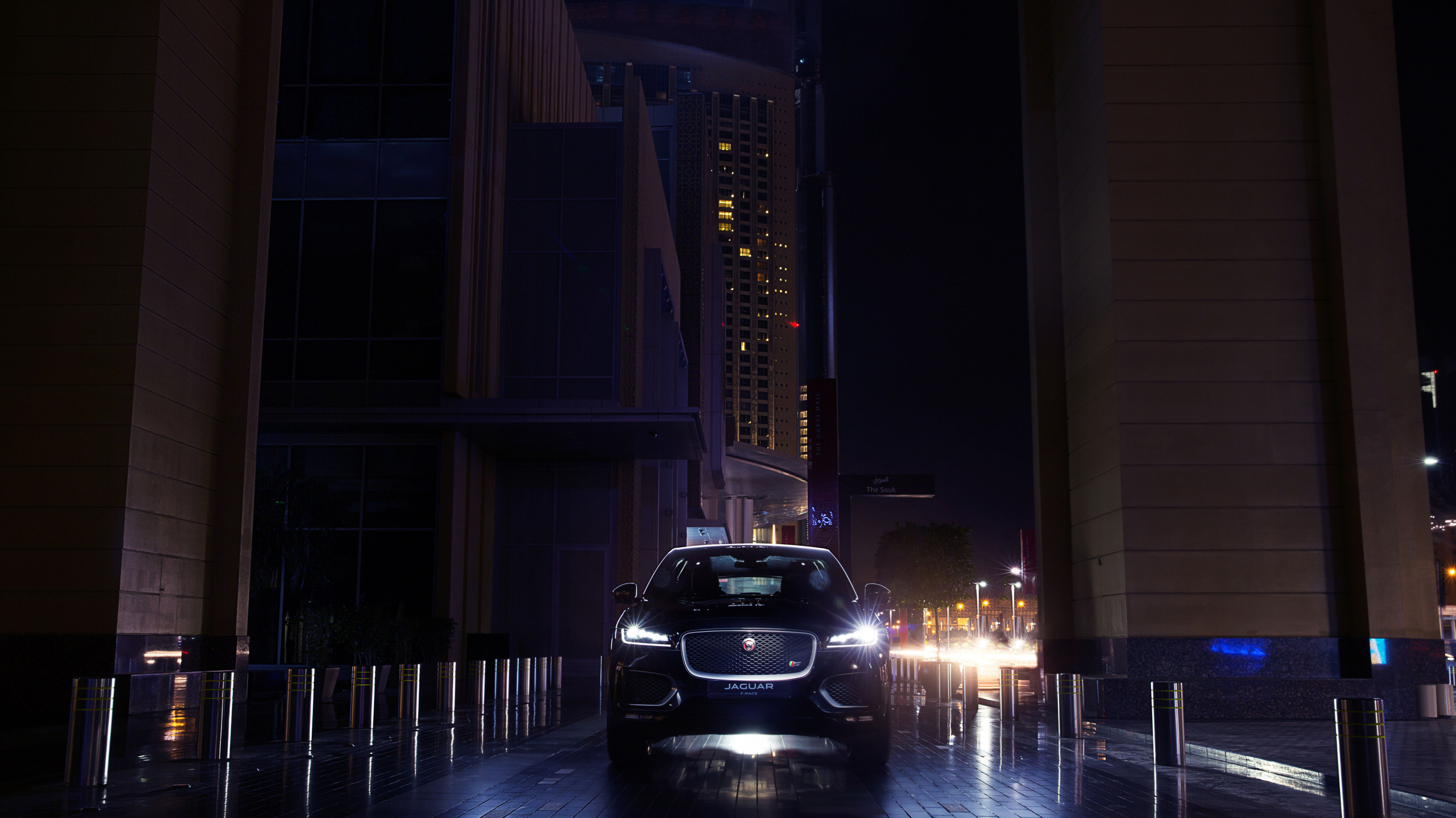 Black Car Parked Near Building During Night Time. Wallpaper in 2560x1440 Resolution