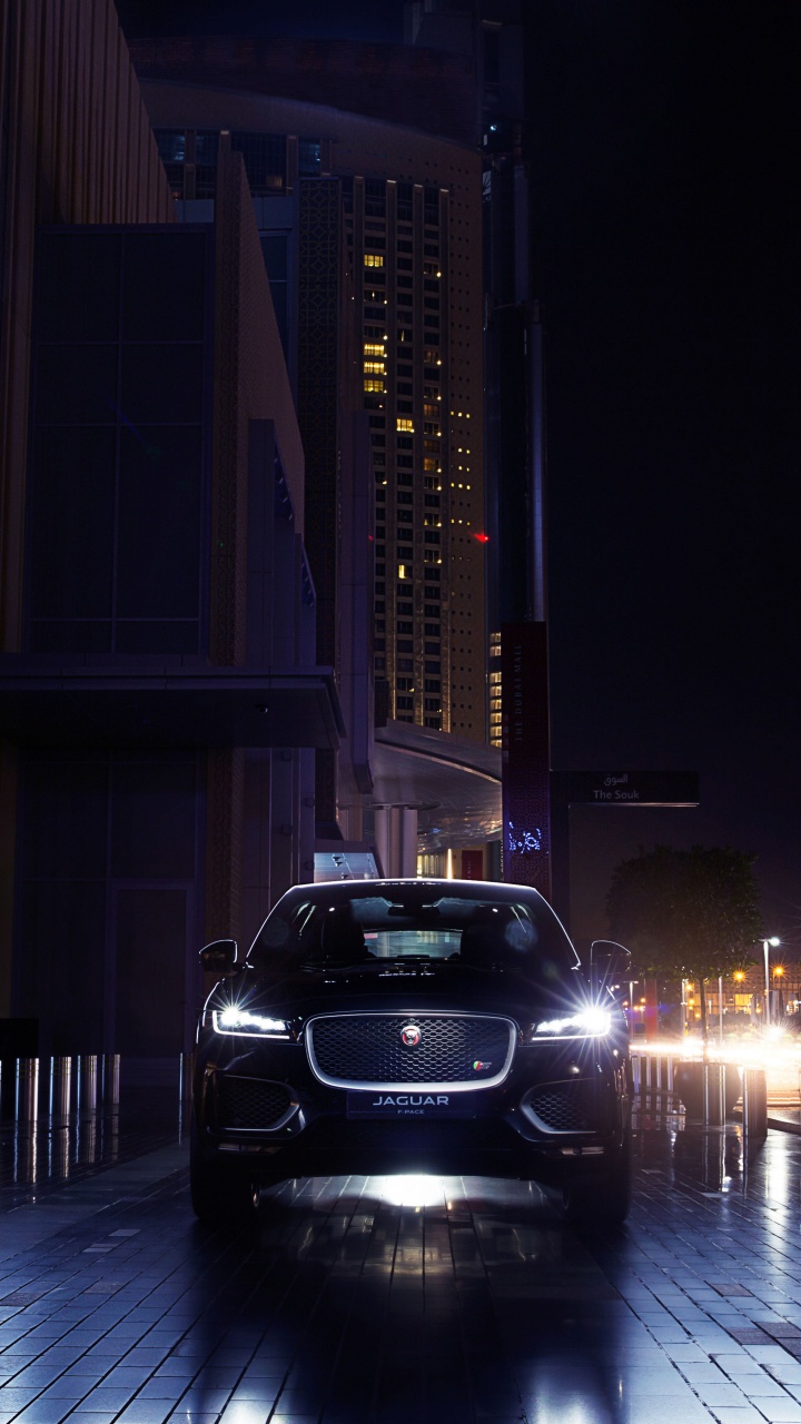 Black Car Parked Near Building During Night Time. Wallpaper in 720x1280 Resolution