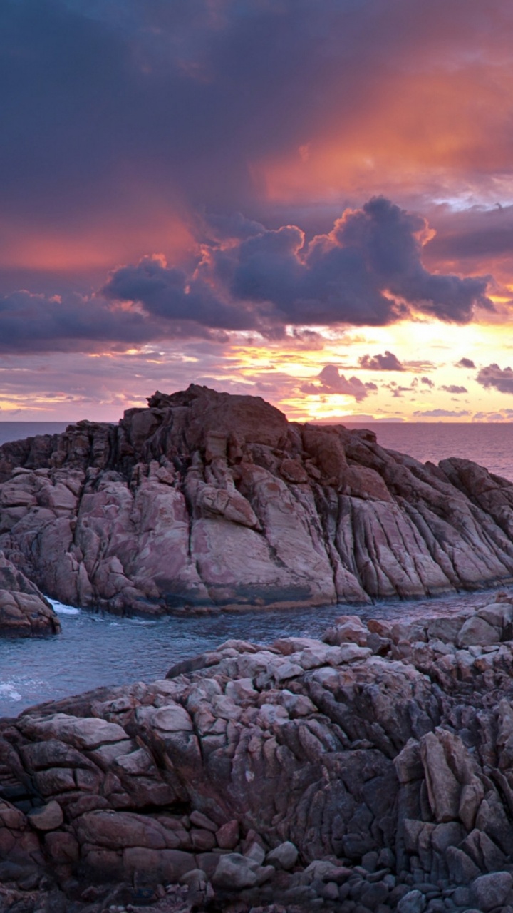 Brown Rock Formation Near Body of Water During Sunset. Wallpaper in 720x1280 Resolution