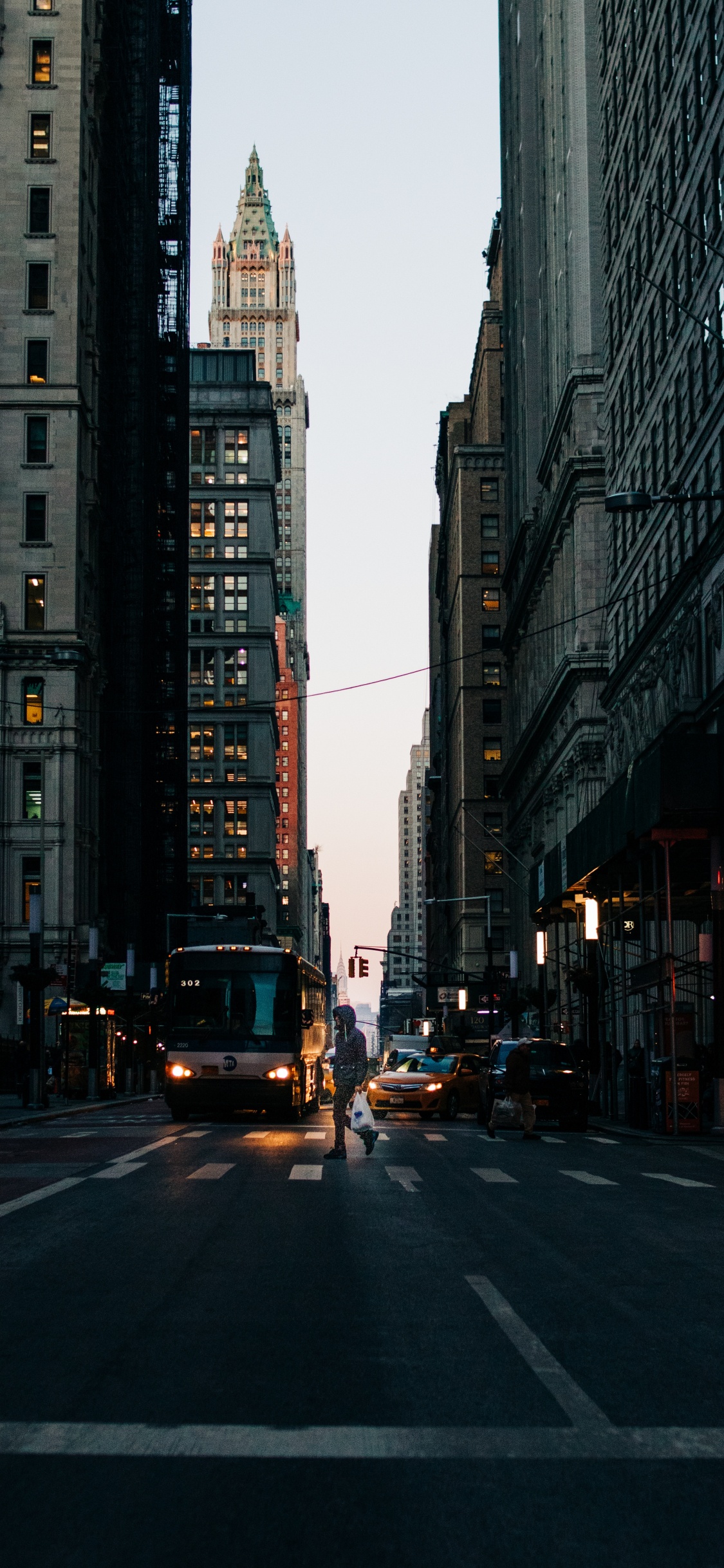 Cars on Road Between High Rise Buildings During Daytime. Wallpaper in 1125x2436 Resolution