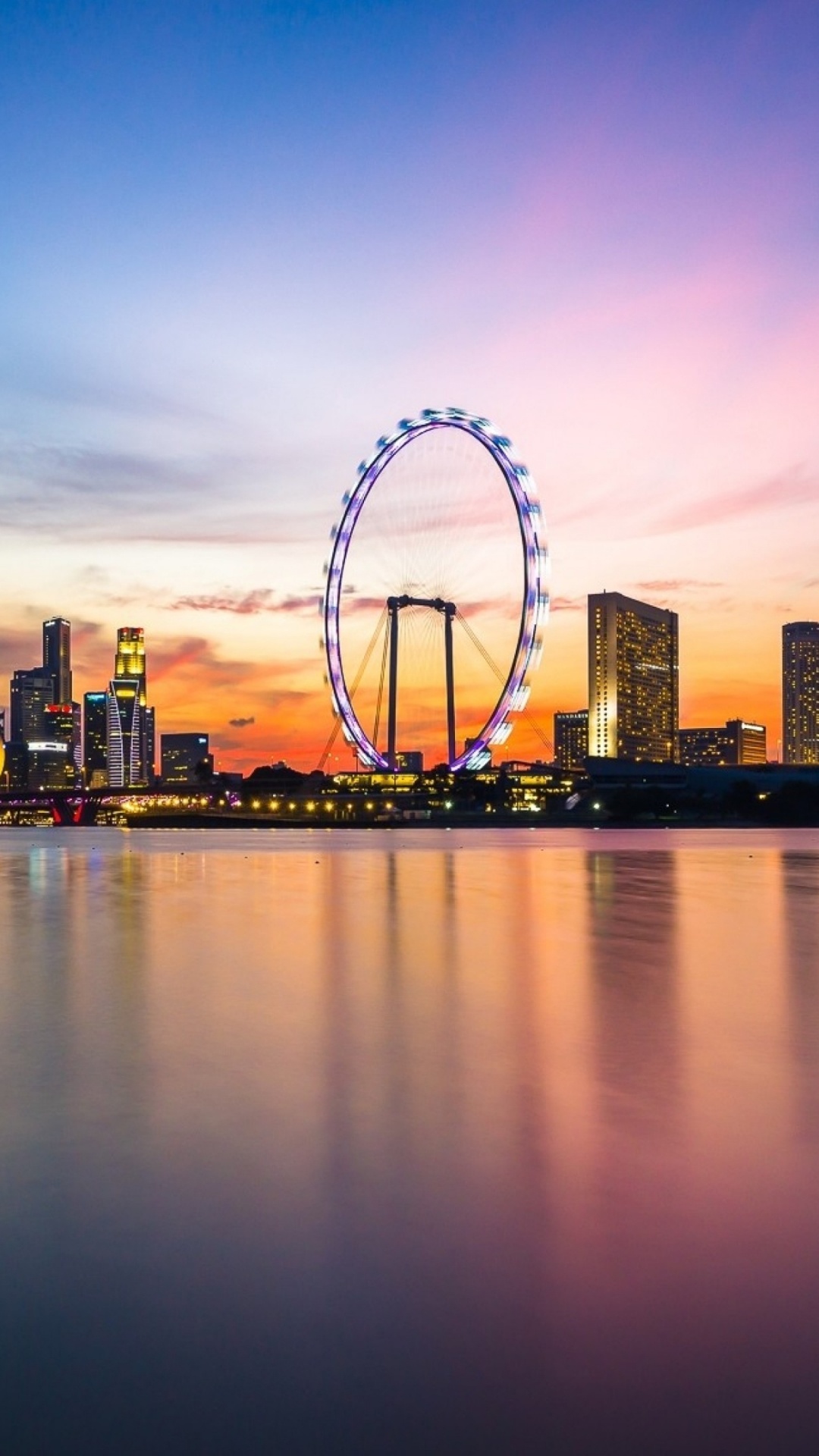 Ferris Wheel Near City Buildings During Sunset. Wallpaper in 1080x1920 Resolution