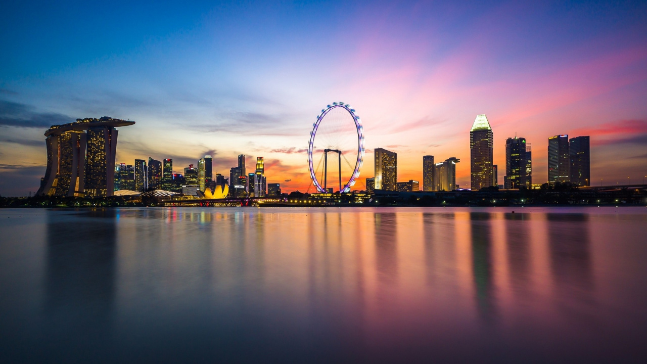 Ferris Wheel Near City Buildings During Sunset. Wallpaper in 1280x720 Resolution