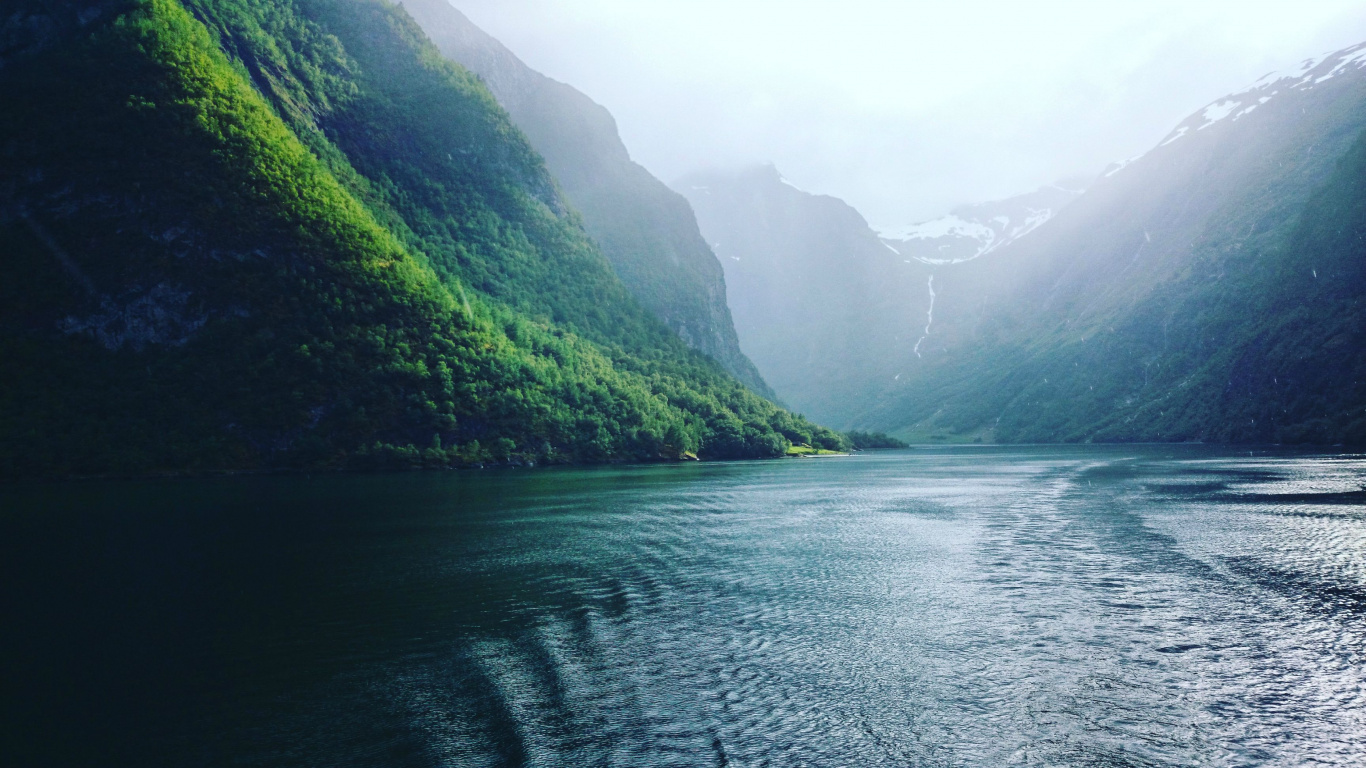 Green Mountains Beside Body of Water During Daytime. Wallpaper in 1366x768 Resolution