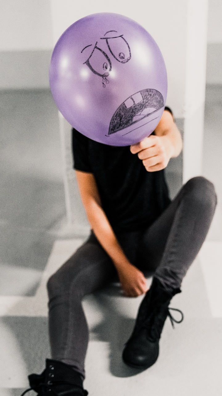 Person Holding Purple Balloon Near White Wall. Wallpaper in 720x1280 Resolution