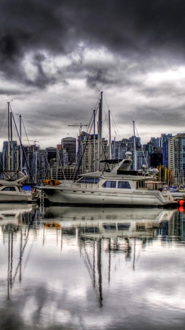 White and Blue Boat on Dock Under Gray Clouds. Wallpaper in 720x1280 Resolution