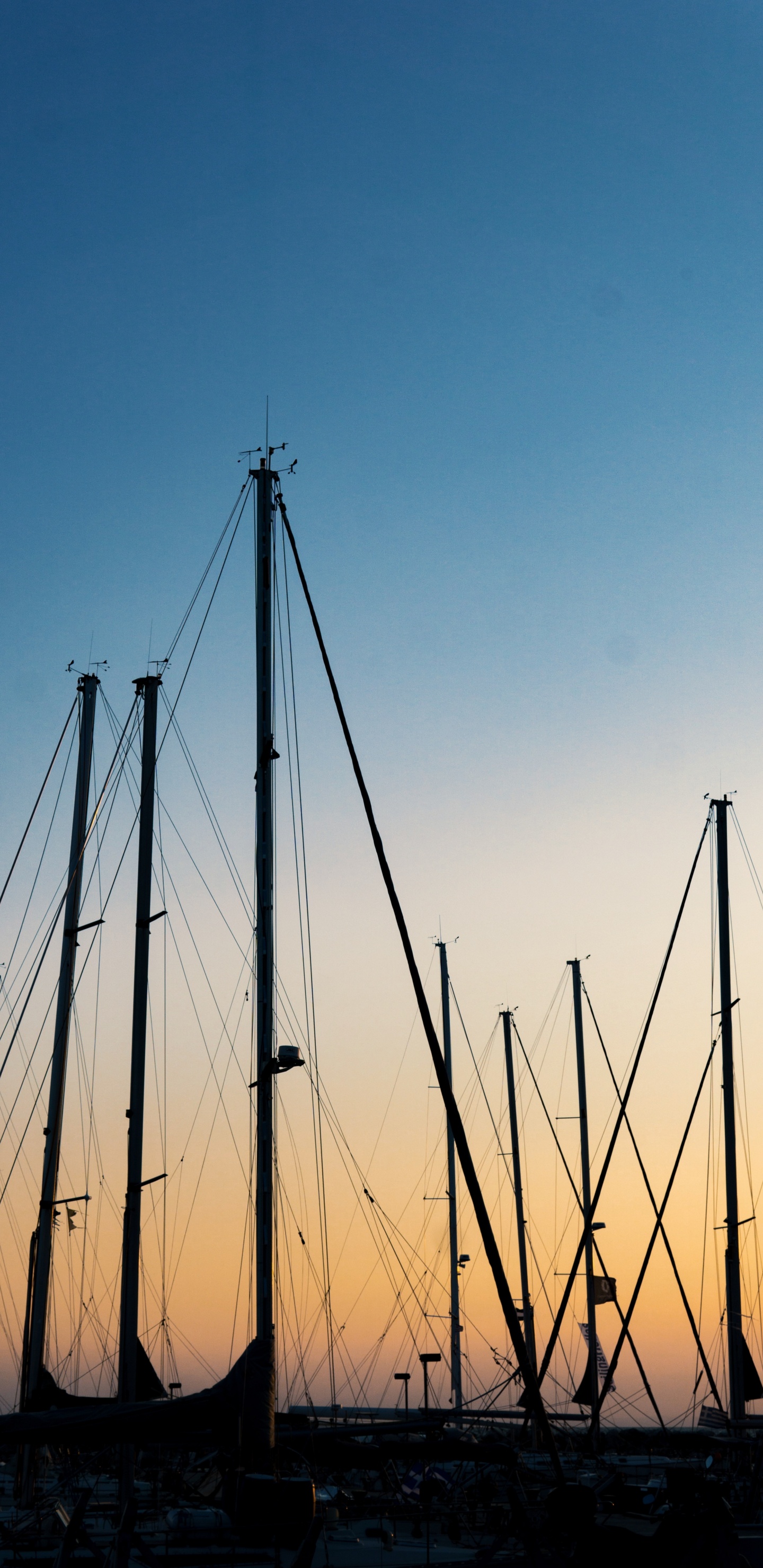 Brown Wooden Poles Under Blue Sky During Daytime. Wallpaper in 1440x2960 Resolution