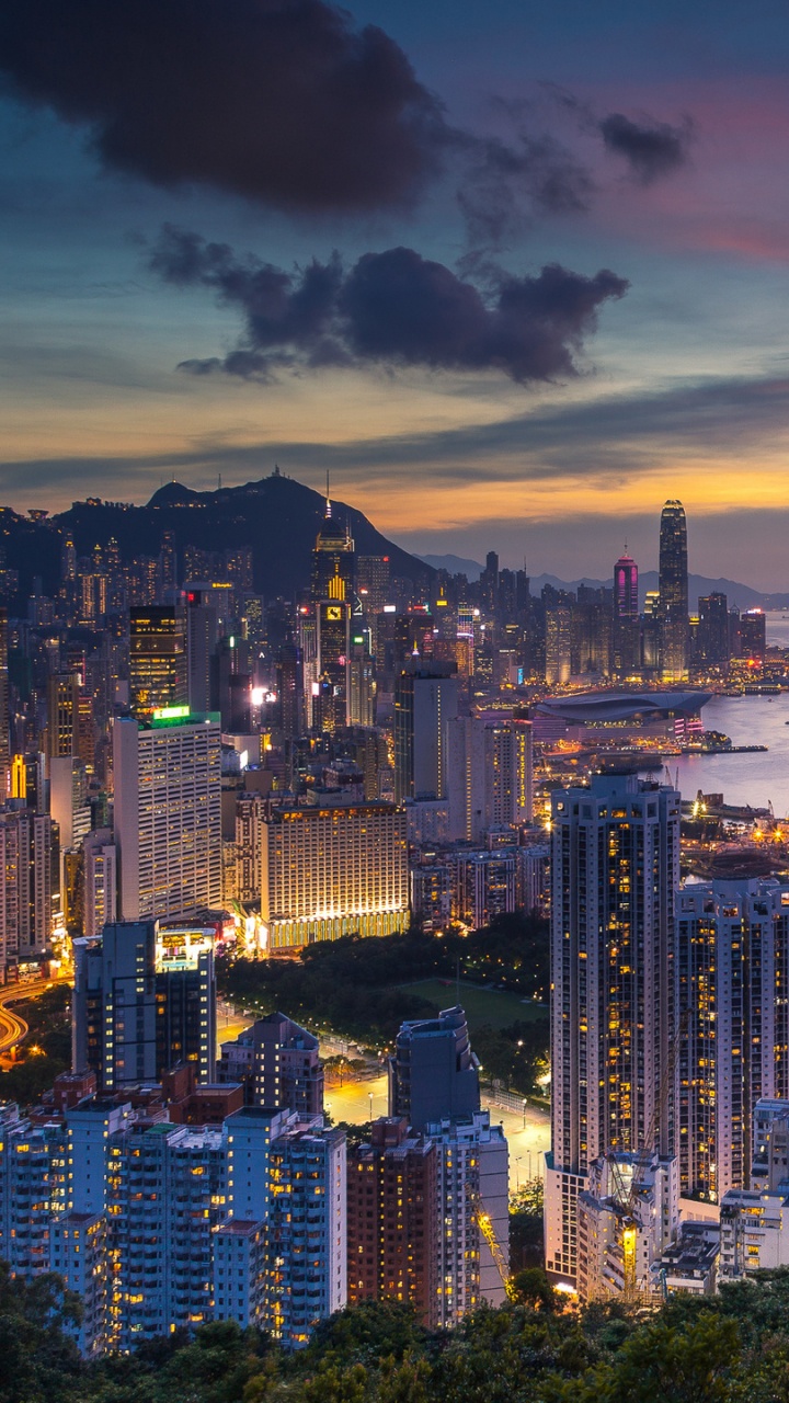 City Skyline Near Sea During Sunset. Wallpaper in 720x1280 Resolution