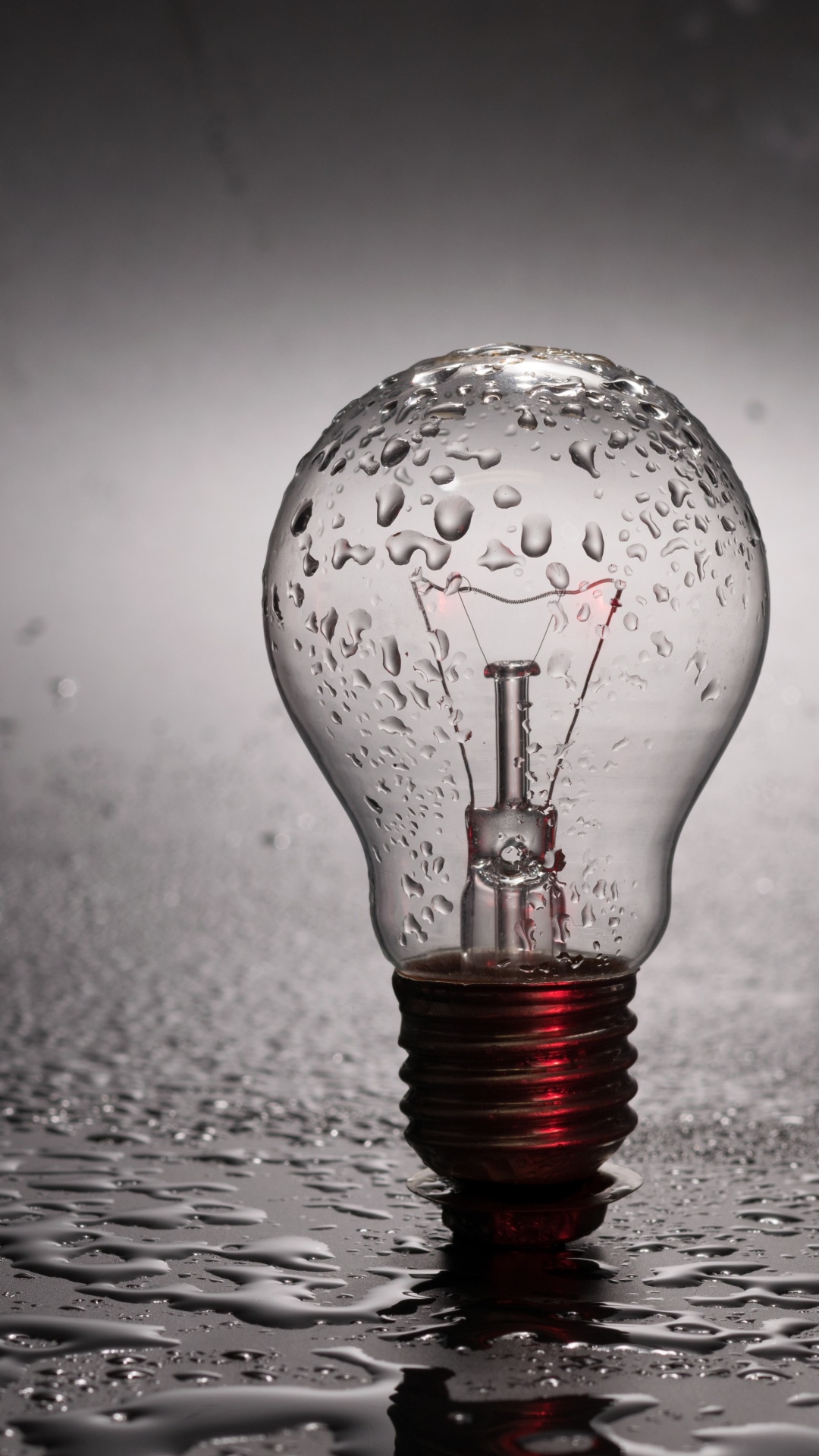 Water Drop on Clear Glass Light Bulb. Wallpaper in 1080x1920 Resolution