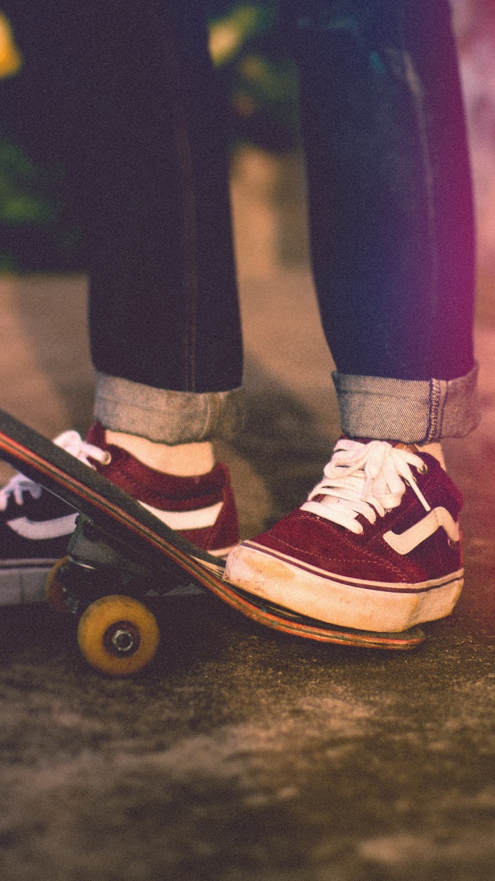 Person in Black Pants and Red and White Sneakers Standing on Black Concrete Floor. Wallpaper in 720x1280 Resolution