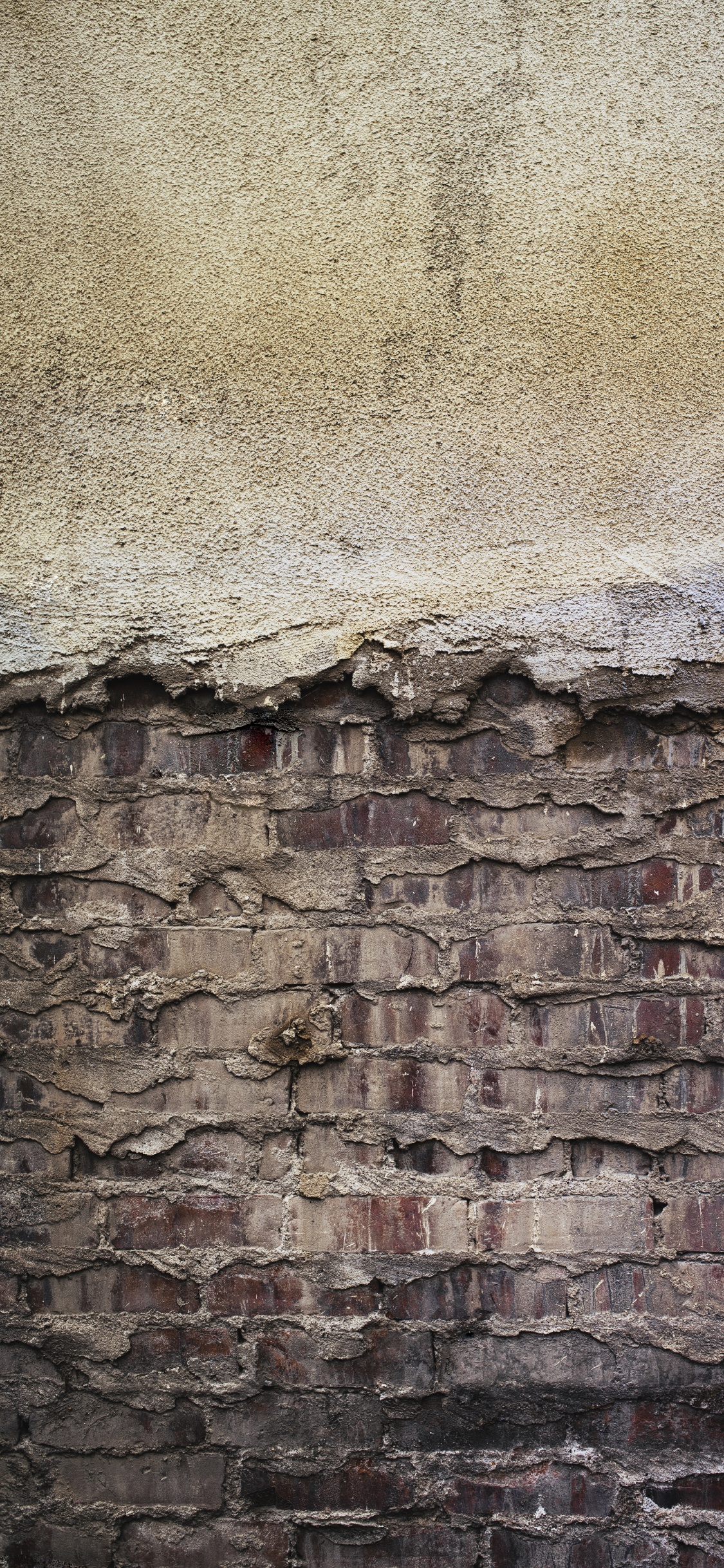 Braune Und Graue Backsteinmauer. Wallpaper in 1125x2436 Resolution