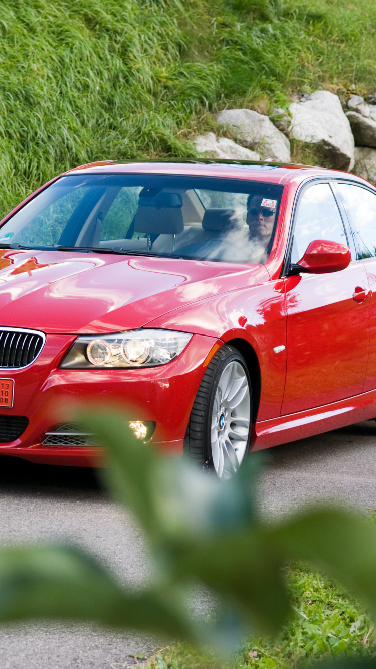 Red Audi Sedan Parked on Green Grass Field During Daytime. Wallpaper in 750x1334 Resolution